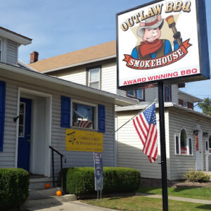 The storefront of Outlaw BBQ Smokehouse, a barbecue restaurant in Hampstead, Maryland.